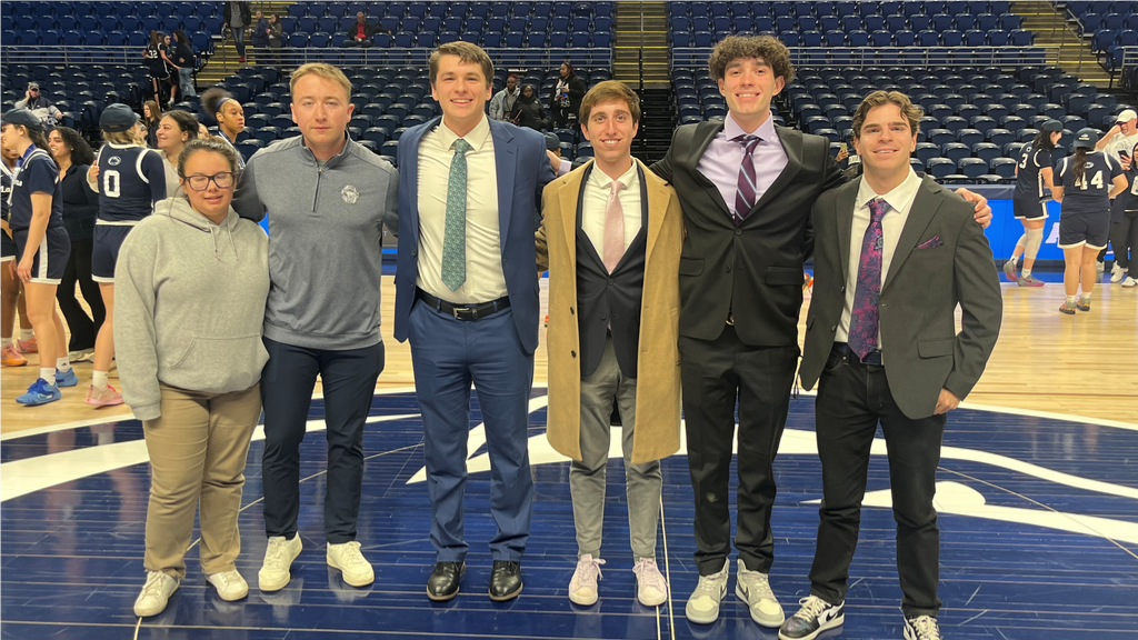 Penn State Comm and Broadcasting students, including Cora Rodriguez (left) and Alec Brown and Evan Smith (far right), who worked the 2025 PSUAC Basketball Championship games at the Bryce Jordan Center are shown posing after the day's completion.