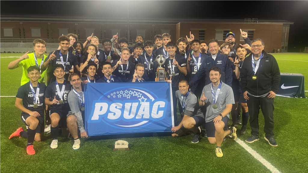 Penn State Lehigh Valley men's soccer poses with the 2024 PSUAC Championship trophy and the PSUAC banner.